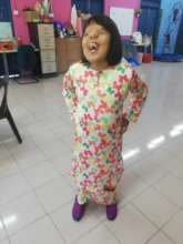Siti loves to smile and stay happy