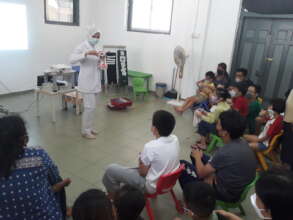 A dental nurse teaching ways to care for our teeth