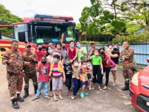 Taking a group photo with the firemen