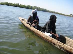 Women oyster farmers loading canoe