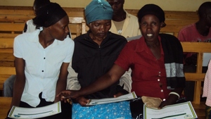 The women reading on their certificates
