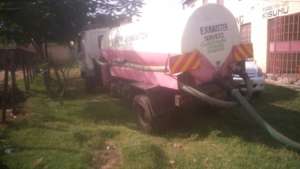 Emptying the 'long drop' toilet