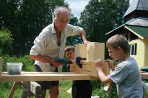 Brothers learning from an experienced volunteer