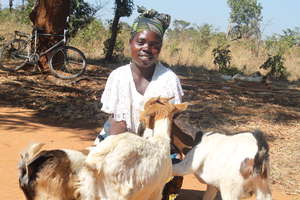 Jane Mwaba is very happy receiving her goats