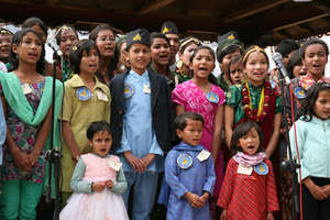 Children sing a welcome song at the opening