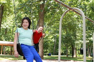Swinging with friends in the public park