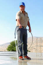 Shahad's father, watering roof to avoid cracking