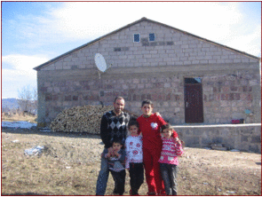 the Ghazaryan family in front of completed home