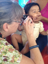 CERI medical volunteer treats baby