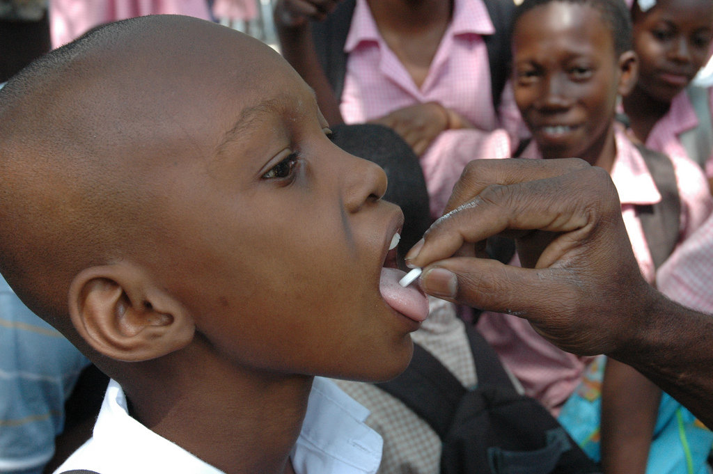Boy getting de-worming pill