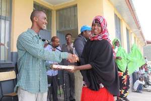 Somali refugee gets an English-Somali dictionary