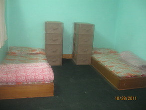 Two beds and dressers in one room