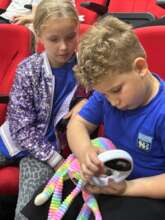 Children search for a microchip at education forum