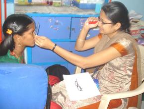 Hospital staff testing the eyesight of a girl