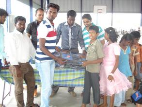 student from TNC College donating bags to children