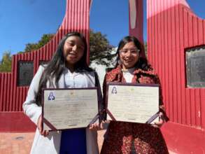 PH scholars, Adriela & Lurdes, with their degrees.
