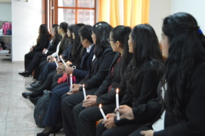 PH Scholars hold candles during the ceremony.