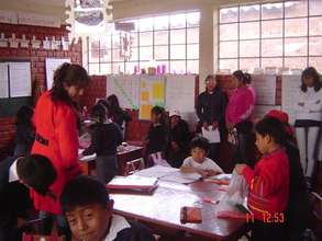 The girls observe a teacher in her classroom
