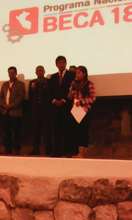 Gloria receives her award on stage in Cusco, Peru.