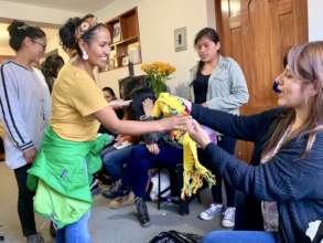 PH scholar, Epifania, receives a donated scarf.