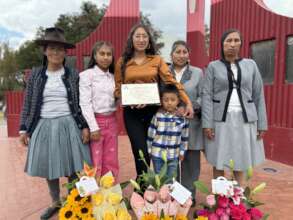 PH scholar, Lizbeth, with her family and degree.