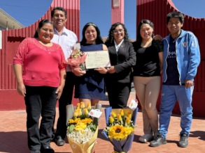 PH scholar, Ruth, with her family and degree.