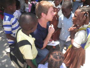 Children receiving books at Ecole Freres Joseph