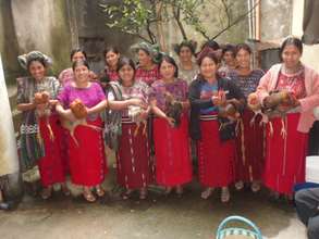 Ixil women show off their new chickens