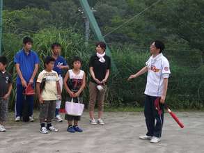 Students and parents play baseball