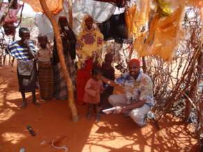 Said meets with a Somali family in their shelter