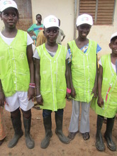 Girls helping to keep their school grounds clean.