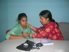 Dr. Sima Rani Mazumder, MBBS treating a patient