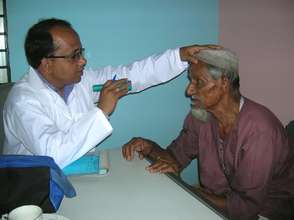 A Doctor from BJAKS examining an elderly patient