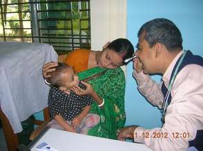 Dr. Mizan treating an infant patient
