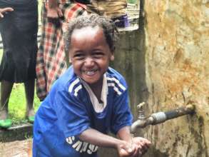 A child washes her hands at an Orbis-supported tap