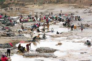 Villagers gather to collect water