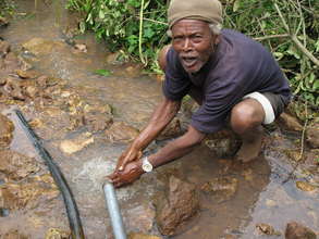 A man cleans his hands with fresh water