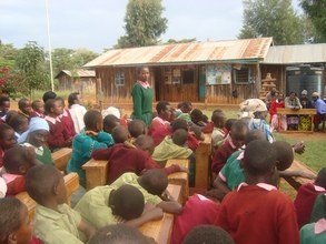Rosemary Nyambura(Standing) addressing the school