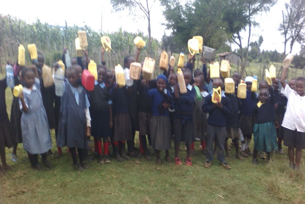 Pupils bring water with jerricans to school