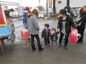 Toddlers waiting in line with parents
