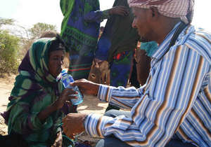 Survival Backpacks team hand out water