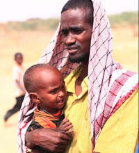 Somali man with baby at Dadaab refugee camp