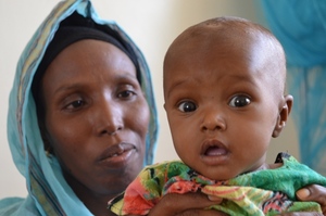 Baby Hawa Mumin held by her aunt Nima Hassan