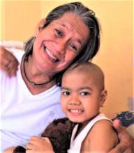 AAI volunteer Pidot with a young cancer patient