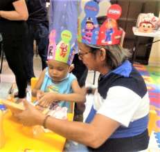 A small child sharing toys with Pidot