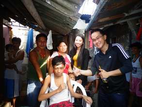 Paul and his family with AAI team in their home