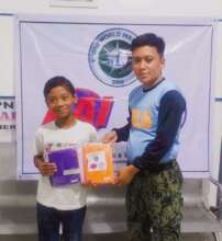 Child receiving new books and supplies