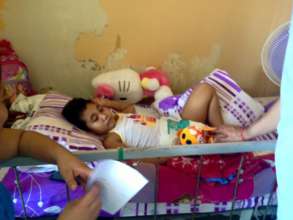 Child in chemotherapy resting with toys