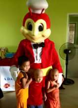 Child undergoing cancer treatment hugs Jolibee