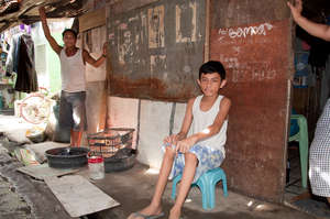 Paul sitting outside shack before wheelchair